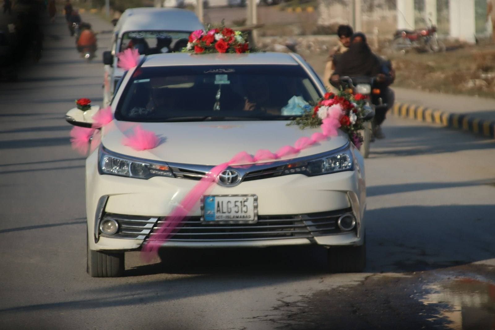 Toyota Corolla decorated with ribbons for a baraat