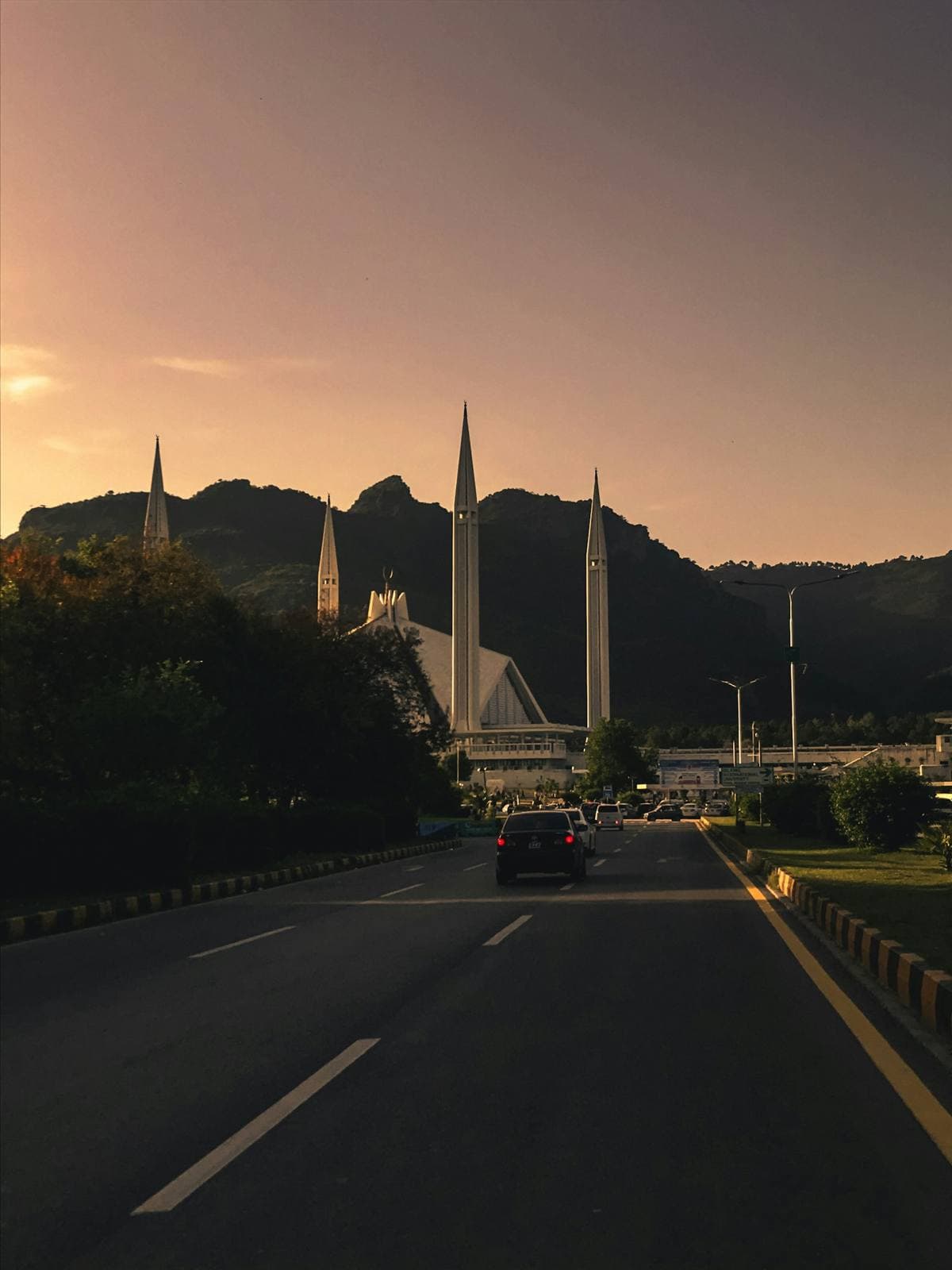 A car on the road to Faisal Mosque, Islamabad, at sunset